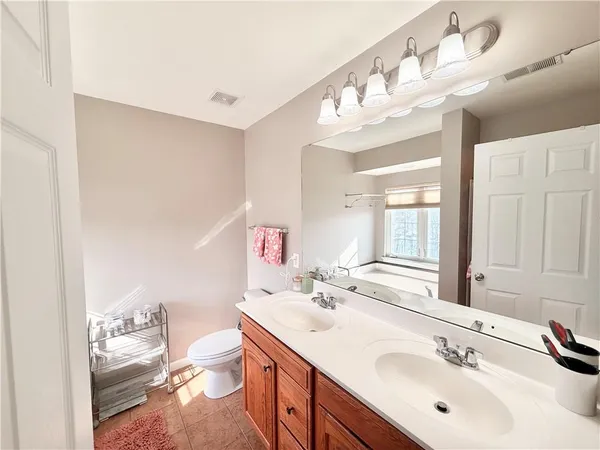a bathroom with a sink vanity mirror and toilet