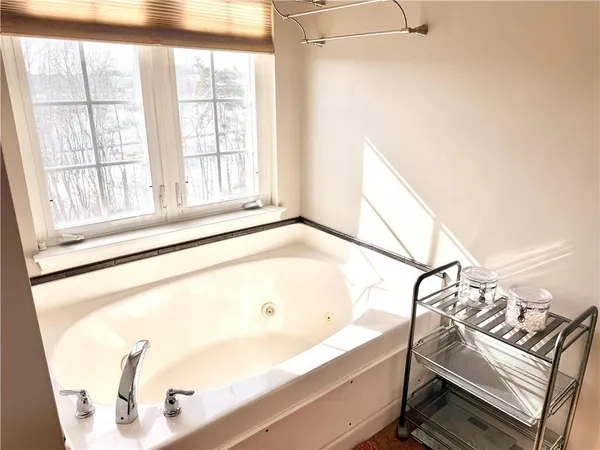 a bathroom with a bathtub and window