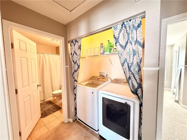 a view of washer and dryer with a kitchen