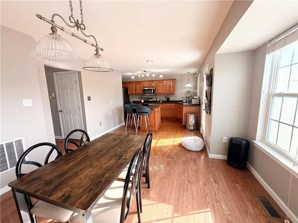 a view of a dining room with furniture window and wooden floor