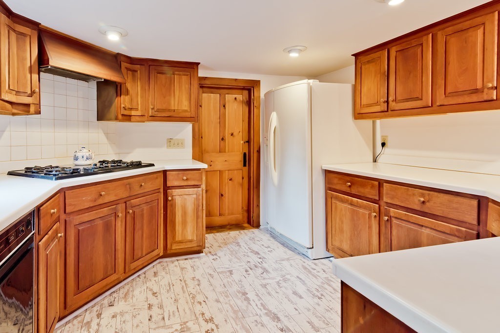 32 Center Road Shirley, MA 01464 - Photo 5 of 30 a kitchen with stainless steel appliances granite countertop a sink dishwasher stove and refrigerator with wooden cabinets