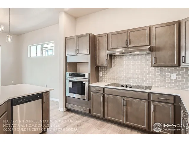 a kitchen with a stove a sink and a microwave