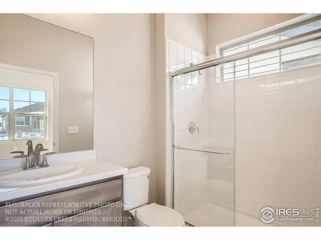 a bathroom with a sink double vanity granite tub and a mirror