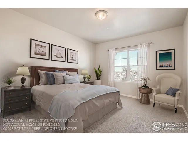 a bedroom with a bed a couch and windows