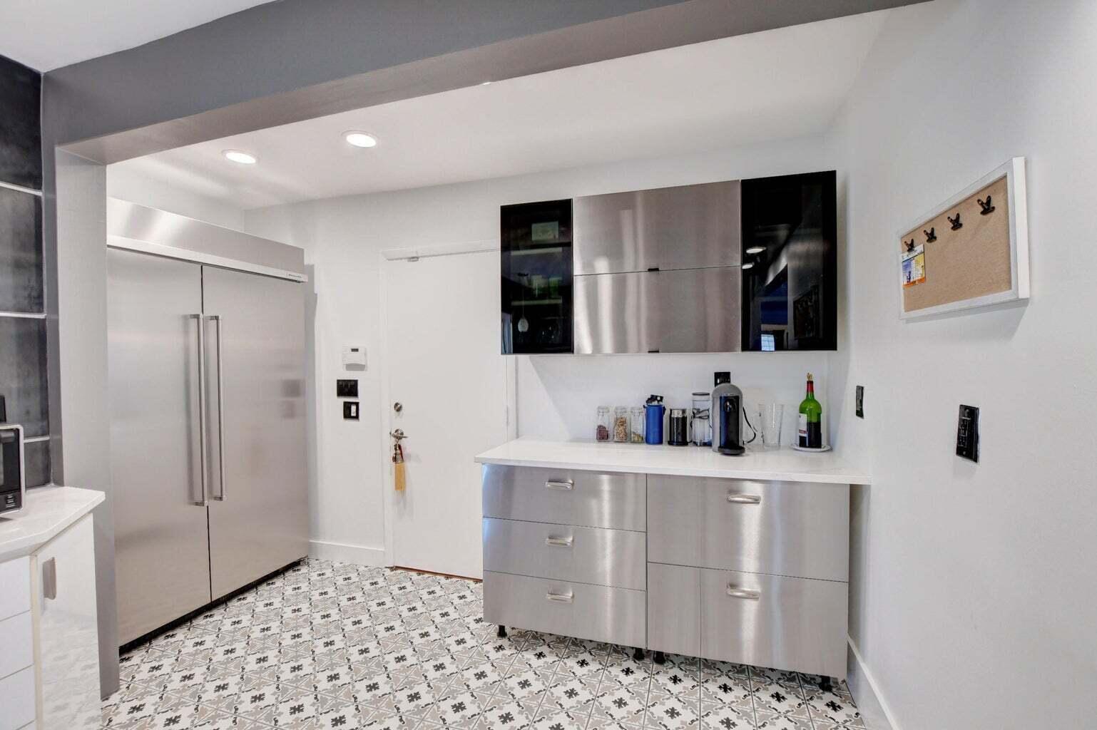 2700 Spanish River Road Boca Raton, FL 33432 - Photo 11 of 19 a kitchen with stainless steel appliances a refrigerator and cabinets