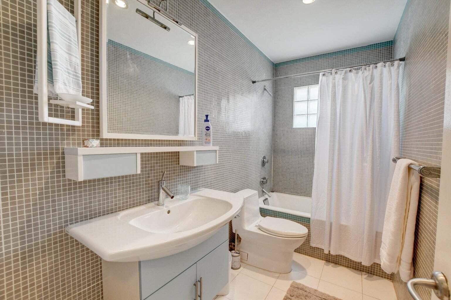 2700 Spanish River Road Boca Raton, FL 33432 - Photo 13 of 19 a bathroom with a sink toilet and shower