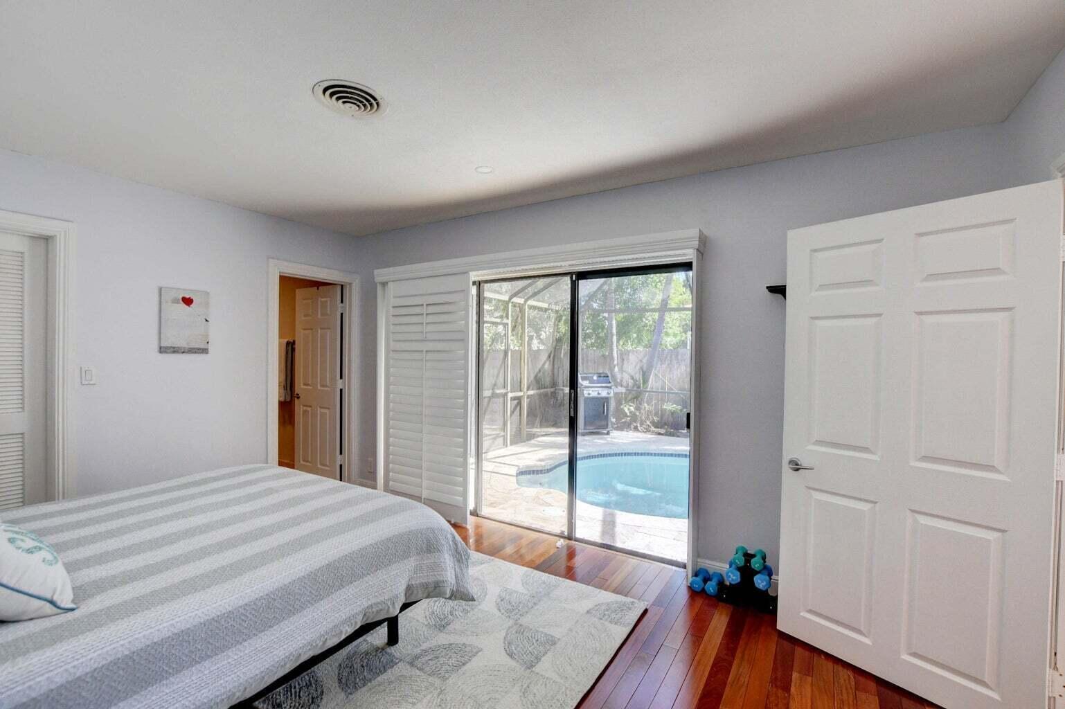 2700 Spanish River Road Boca Raton, FL 33432 - Photo 15 of 19 a bedroom with a bed and wooden floor