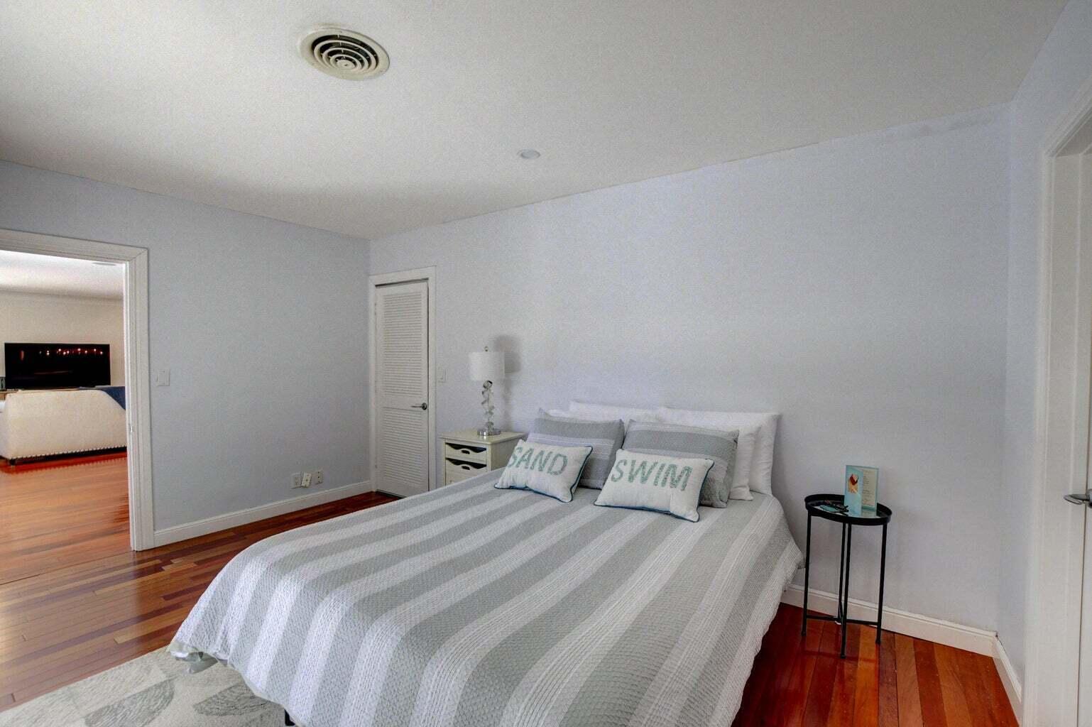 2700 Spanish River Road Boca Raton, FL 33432 - Photo 16 of 19 a bedroom with a bed and a mirror