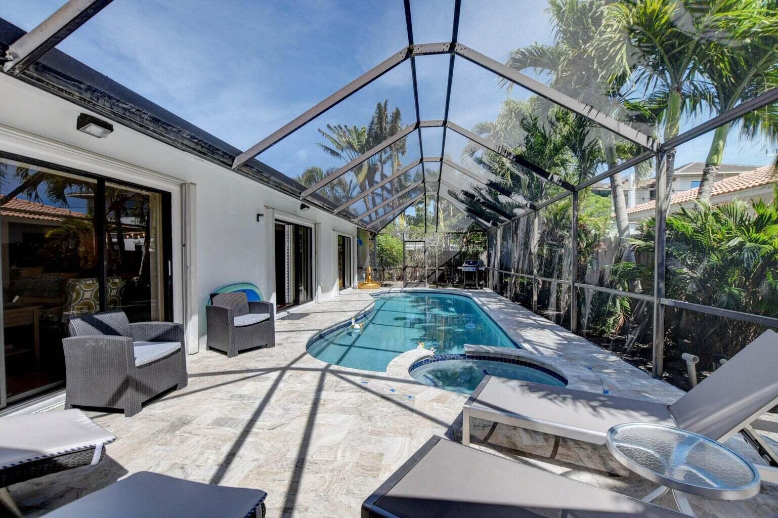 2700 Spanish River Road Boca Raton, FL 33432 - Photo 18 of 19 a view of a patio with table and chairs potted plants with wooden floor and fence