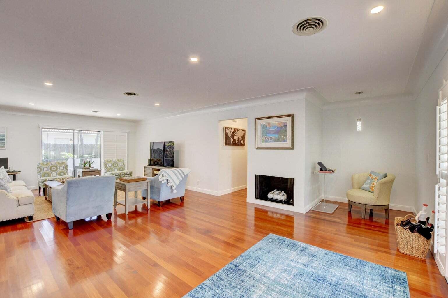2700 Spanish River Road Boca Raton, FL 33432 - Photo 5 of 19 a living room with furniture and a fireplace