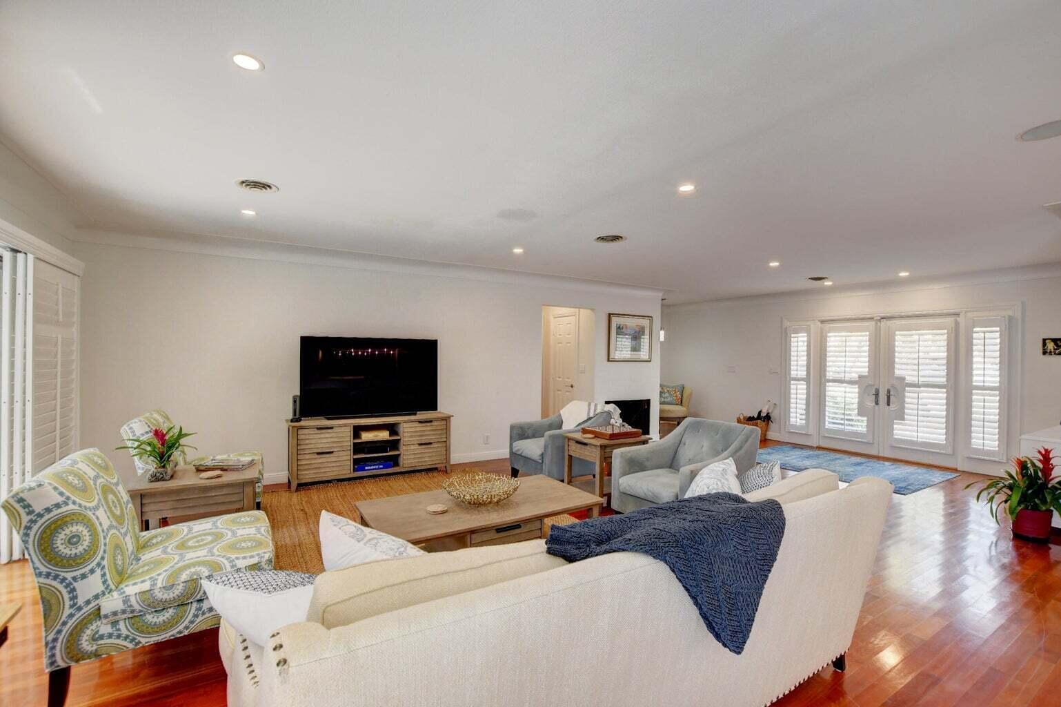 2700 Spanish River Road Boca Raton, FL 33432 - Photo 8 of 19 a living room with furniture and a flat screen tv