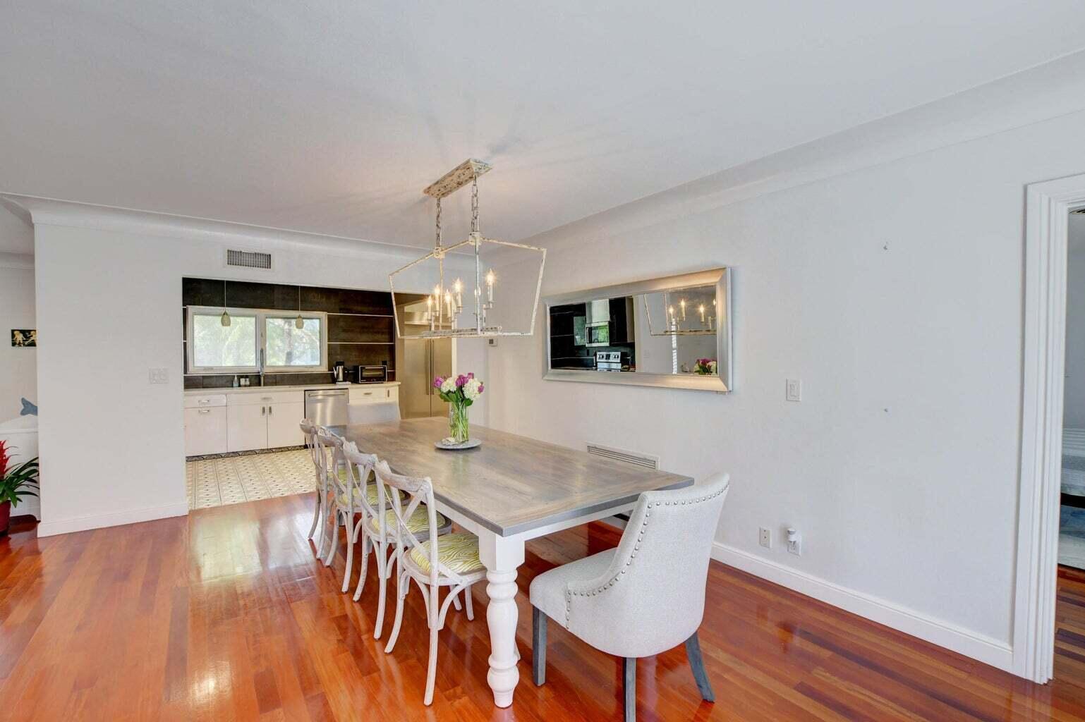 2700 Spanish River Road Boca Raton, FL 33432 - Photo 10 of 19 a view of a dining room with furniture and wooden floor