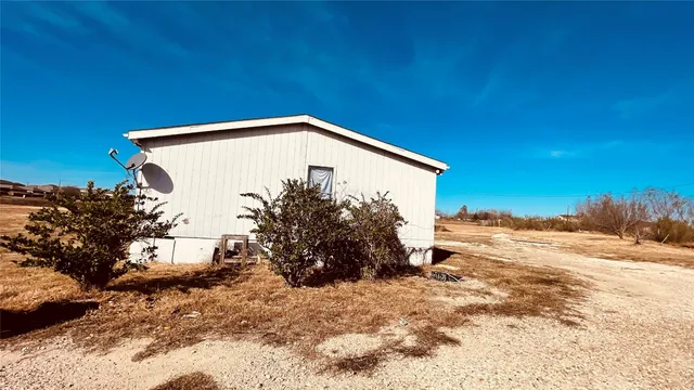 a view of a house with a snow in the background