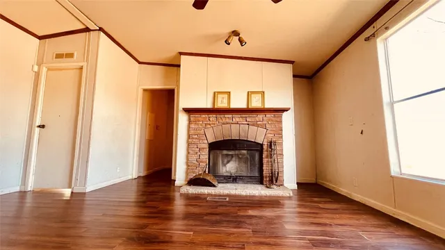 a living room with a fireplace and a wooden floor
