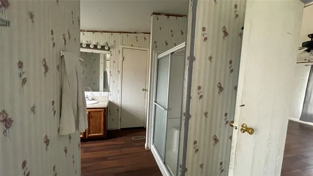 a view of a bathroom with a sink and wooden floor