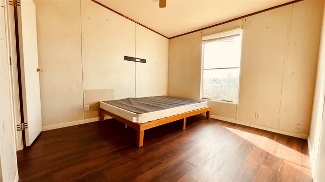a room with a window and wooden floor