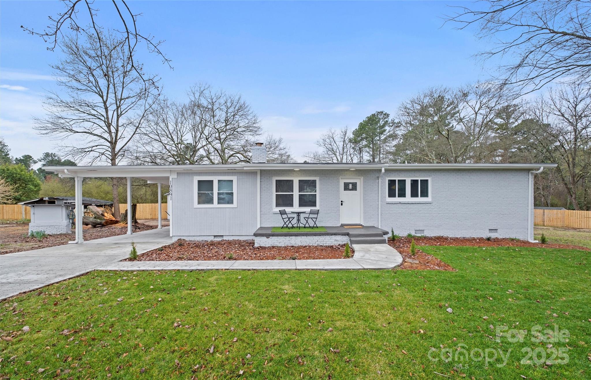 a house view with a seating space and garden