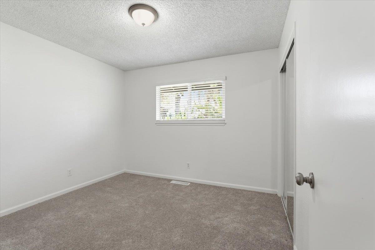 209 Tokay Avenue Modesto, CA 95350 - Photo 13 of 30 an empty room with windows
