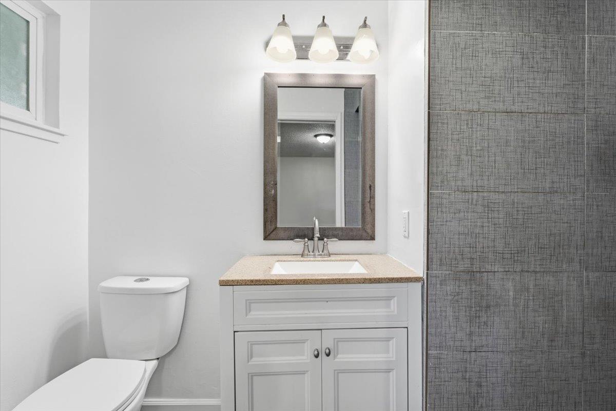209 Tokay Avenue Modesto, CA 95350 - Photo 16 of 30 a bathroom with a toilet sink and mirror