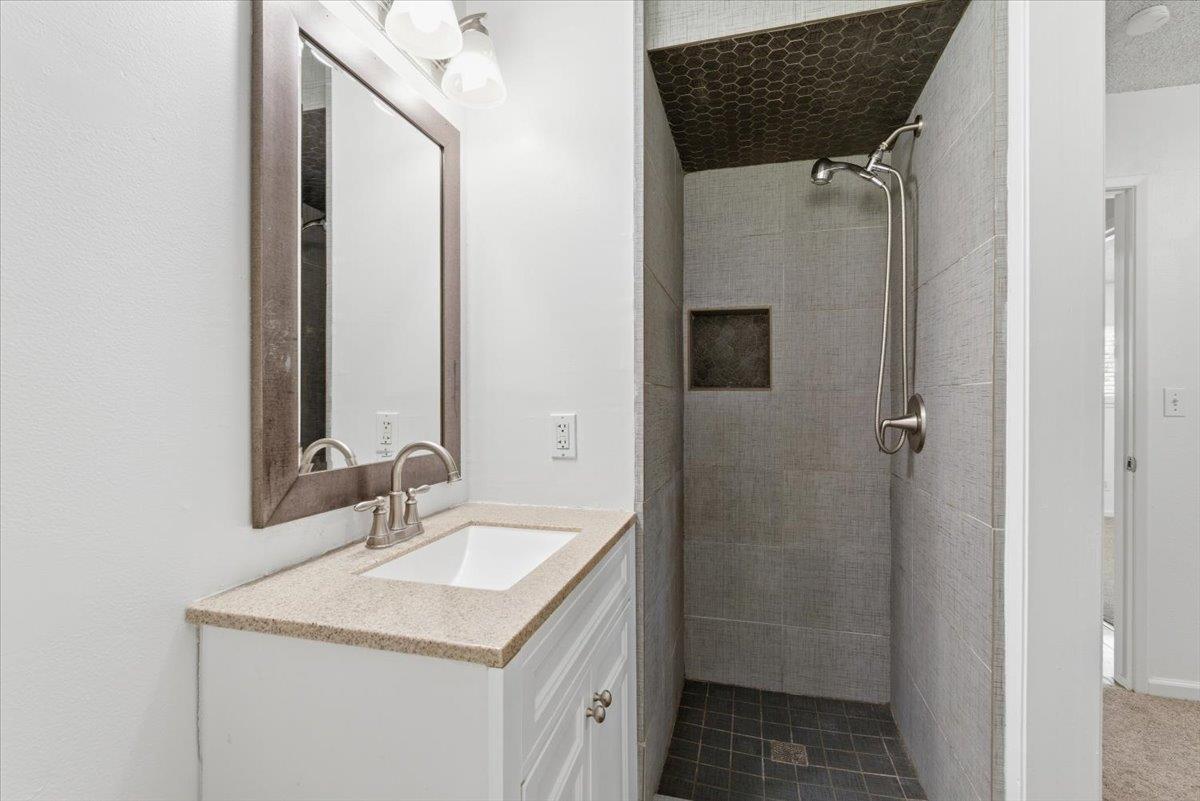 209 Tokay Avenue Modesto, CA 95350 - Photo 17 of 30 a bathroom with a sink vanity and a mirror