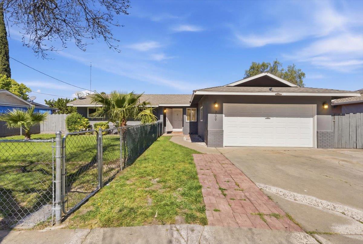 209 Tokay Avenue Modesto, CA 95350 - Photo 2 of 30 a front view of a house with a yard