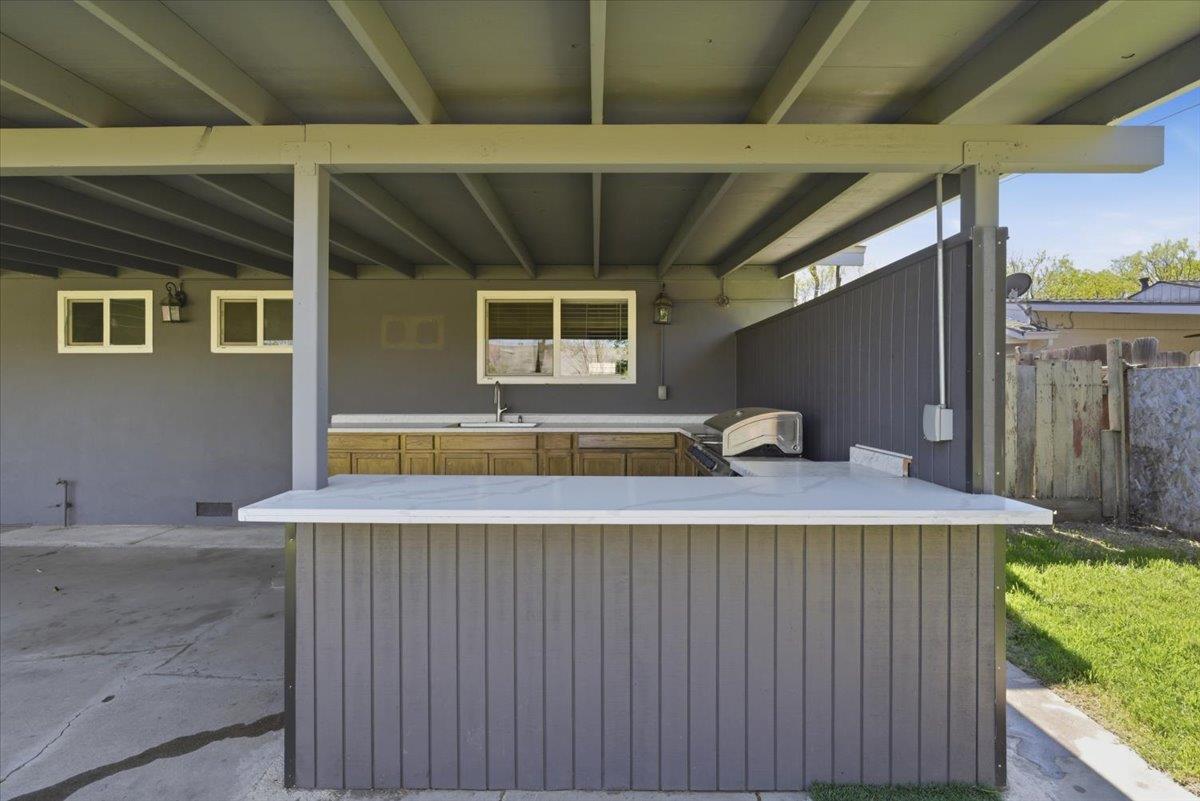 209 Tokay Avenue Modesto, CA 95350 - Photo 23 of 30 a dinning table under an umbrella
