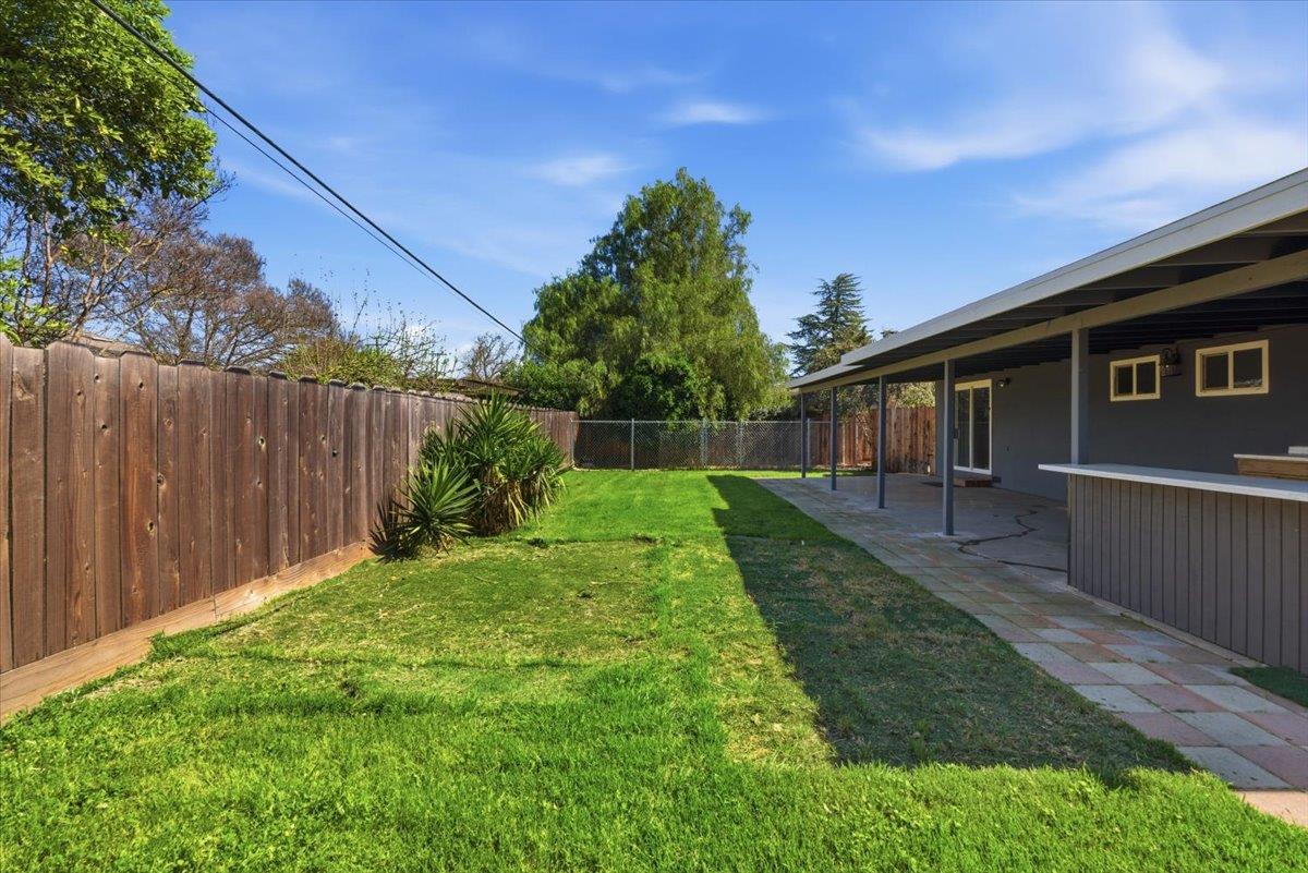 209 Tokay Avenue Modesto, CA 95350 - Photo 25 of 30 a view of a backyard with plants and a backyard