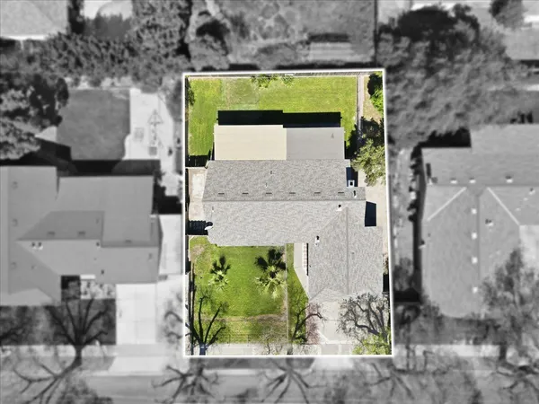 an aerial view of a house with a swimming pool