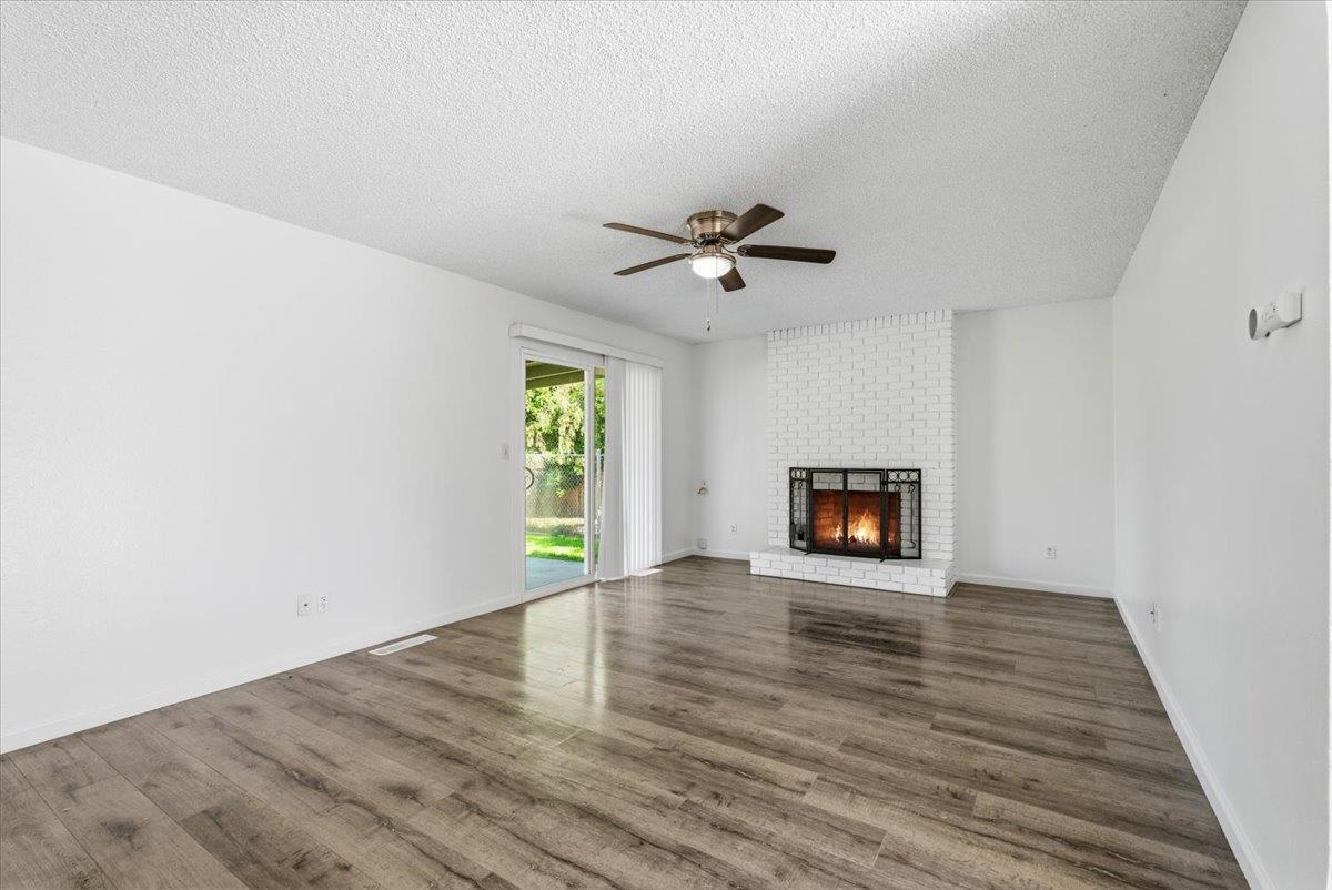 209 Tokay Avenue Modesto, CA 95350 - Photo 4 of 30 a view of an empty room with a window and a fireplace