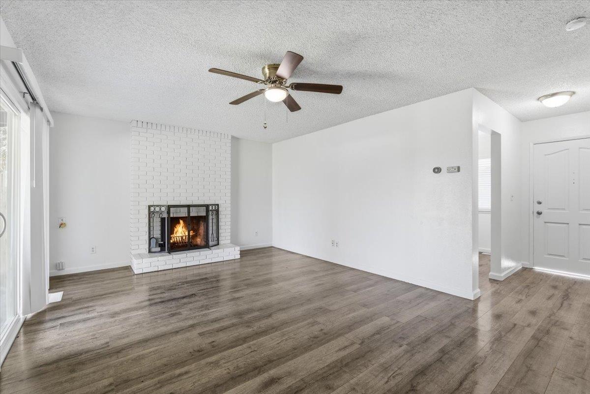 209 Tokay Avenue Modesto, CA 95350 - Photo 5 of 30 a view of an empty room with wooden floor and a window