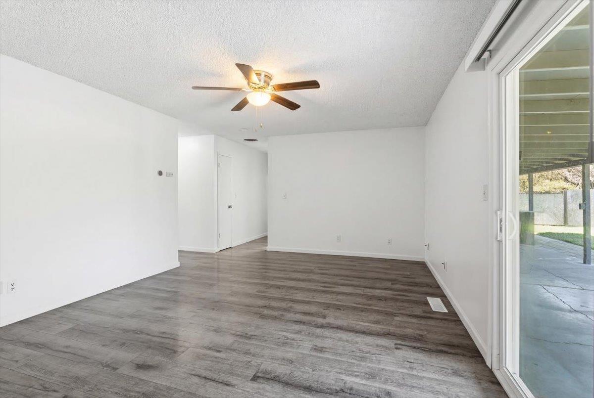 209 Tokay Avenue Modesto, CA 95350 - Photo 6 of 30 a view of empty room with wooden floor