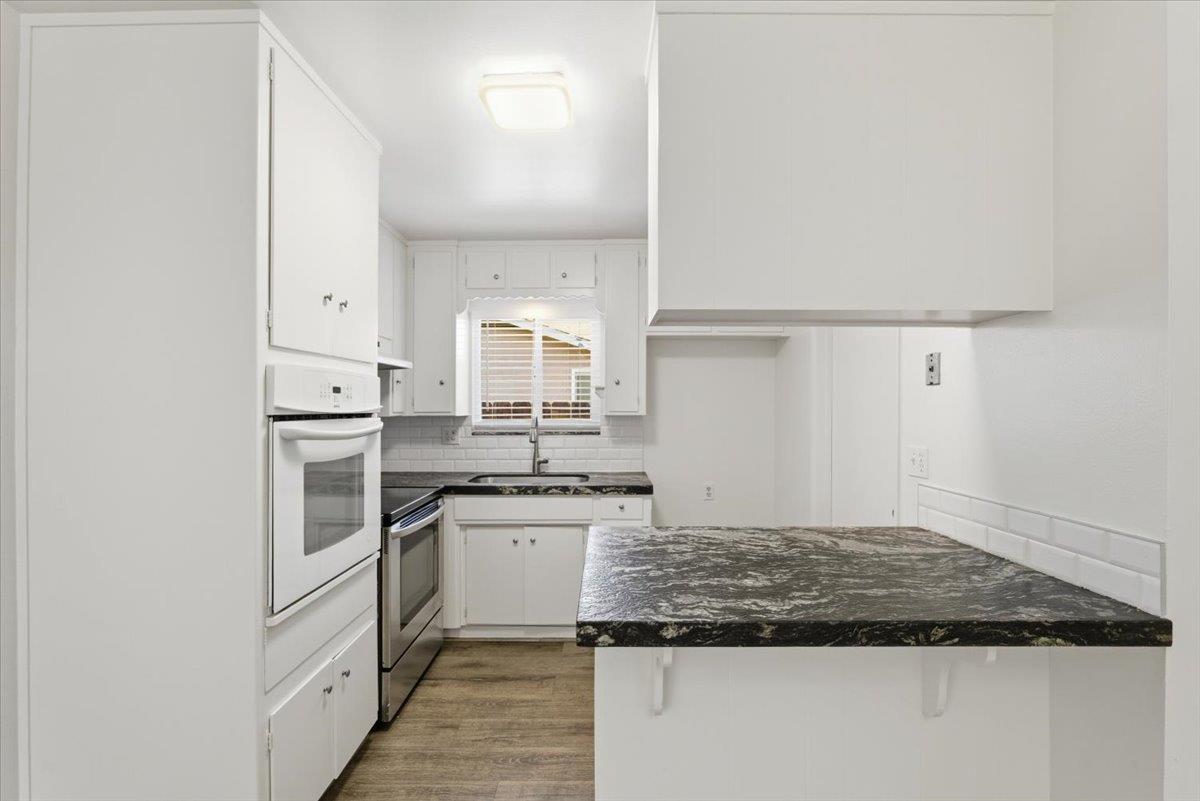 209 Tokay Avenue Modesto, CA 95350 - Photo 8 of 30 a kitchen with white cabinets and appliances