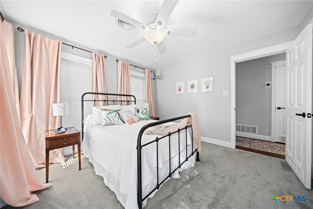 2509 Forest Trail Temple, TX 76502 - Photo 25 of 42 a bedroom with a bed and a chandelier