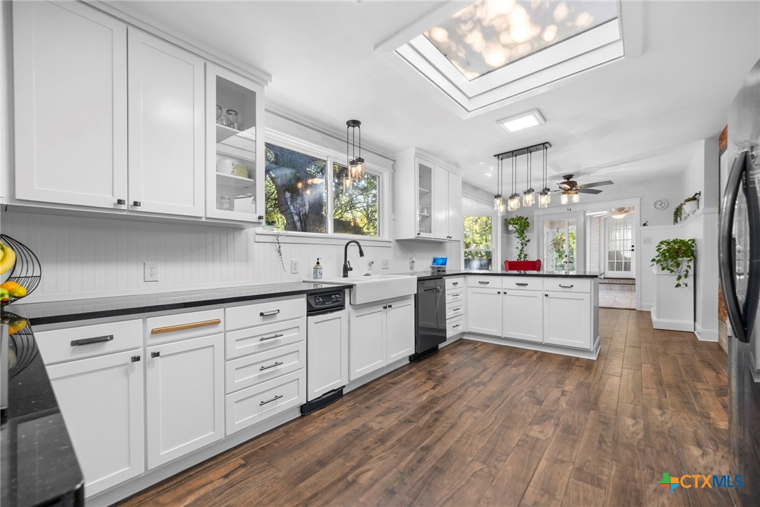 2509 Forest Trail Temple, TX 76502 - Photo 9 of 42 a kitchen with stainless steel appliances sink cabinets and wooden floor