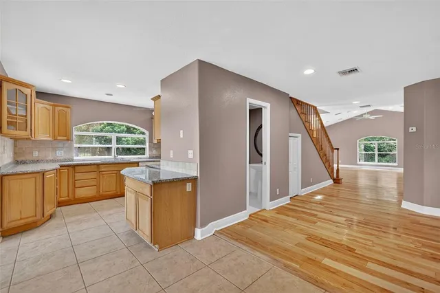 a kitchen with stainless steel appliances granite countertop a sink a stove and a refrigerator