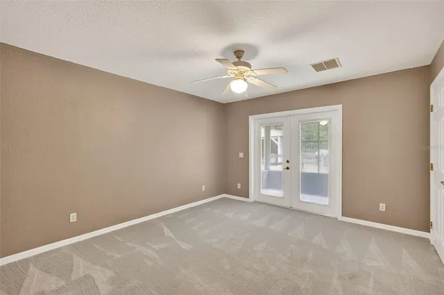 a view of a green field with lots of bushes