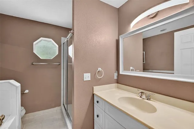 a view of a city with lush green forest