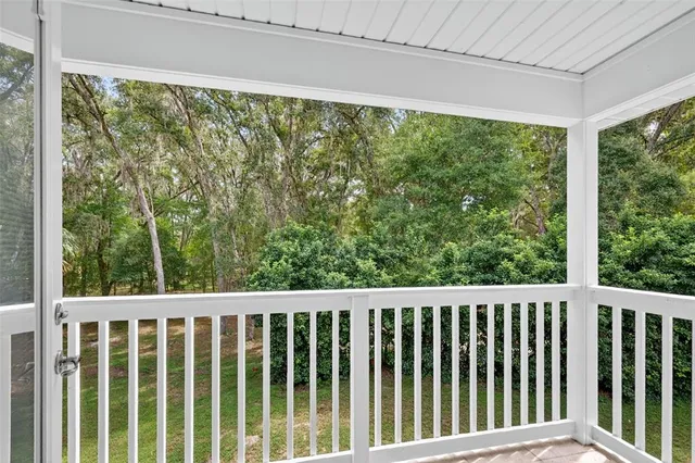 a view of a room with wooden floor and a porch