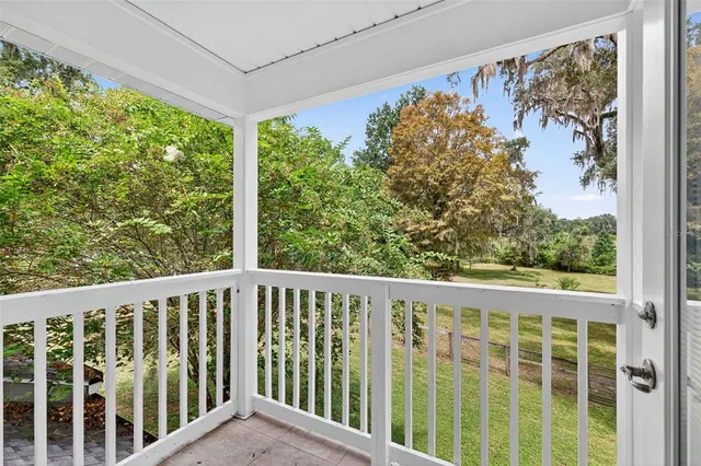 a view of an empty room with a window and fireplace