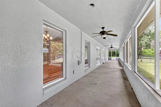 a view of wooden floor and a chandelier in a room