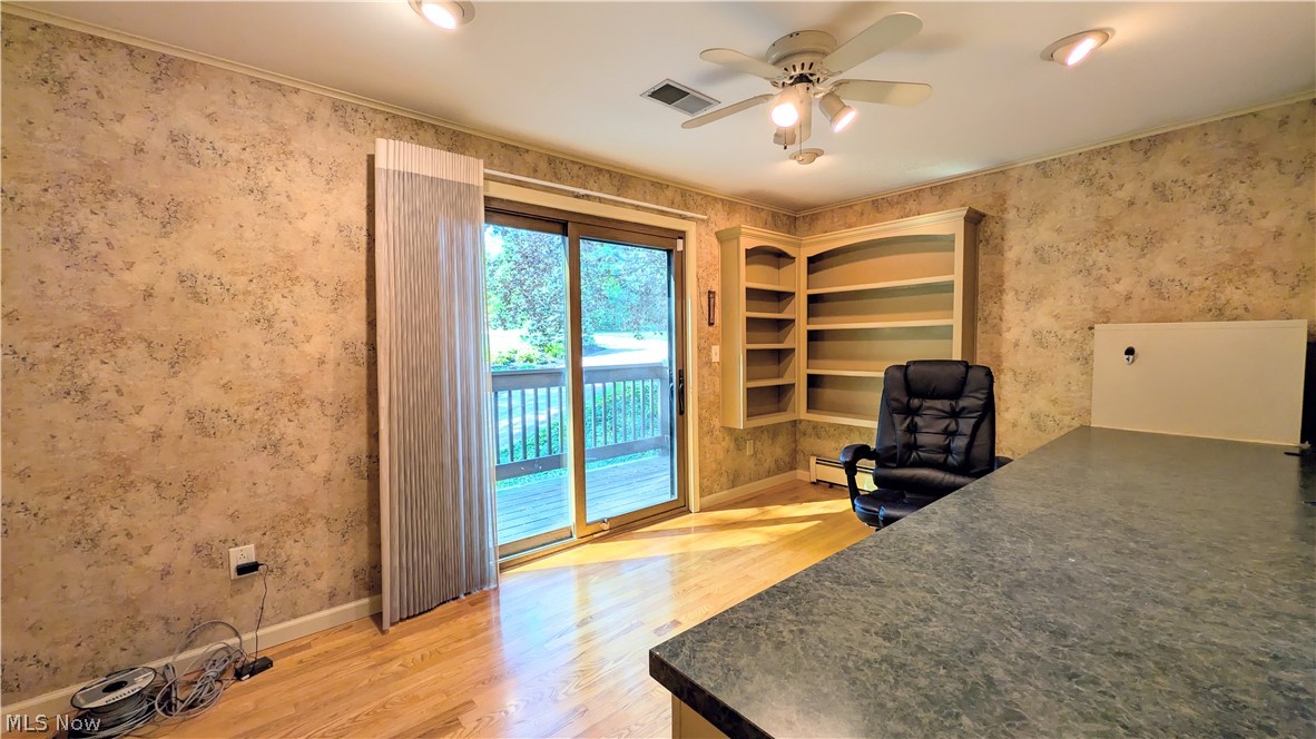 6409 Old Woods Road Ashtabula, OH 44004 - Photo 13 of 43 Spacious room featuring wood-finish flooring, built-in shelving, and a ceiling fan with integrated lighting