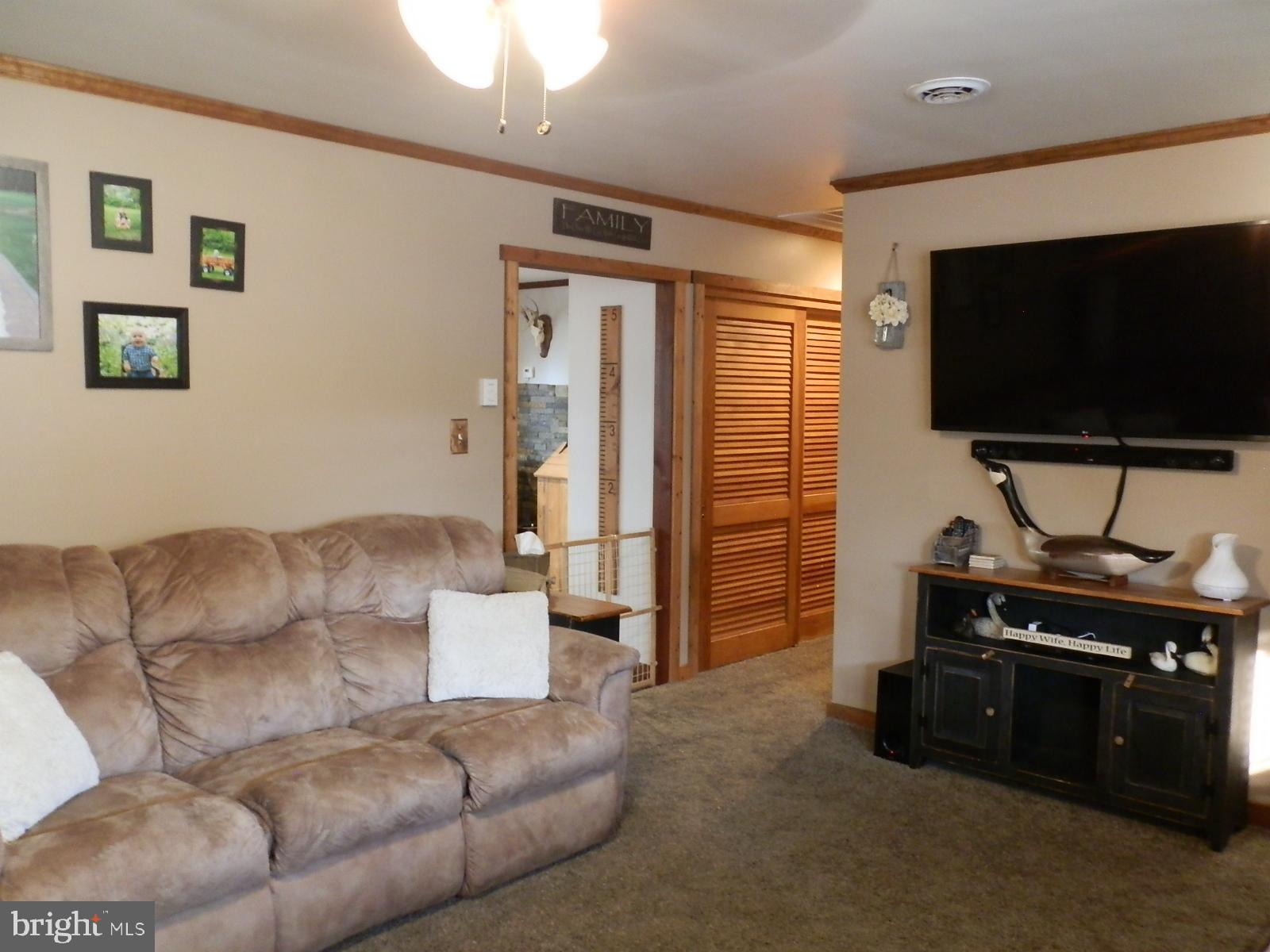 10 Georgia Road Pennsville, NJ 08070 - Photo 43 of 48 a living room with furniture and a flat screen tv