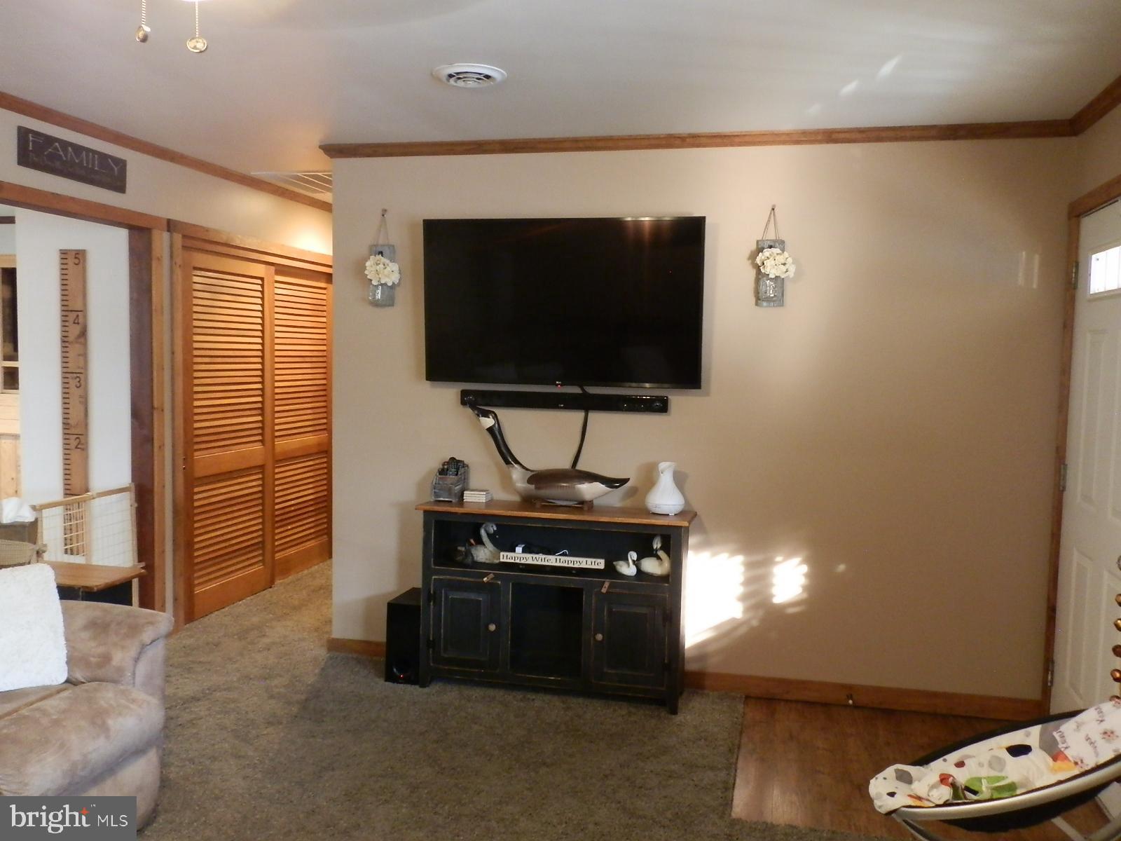 10 Georgia Road Pennsville, NJ 08070 - Photo 44 of 48 a living room with furniture and a flat screen tv