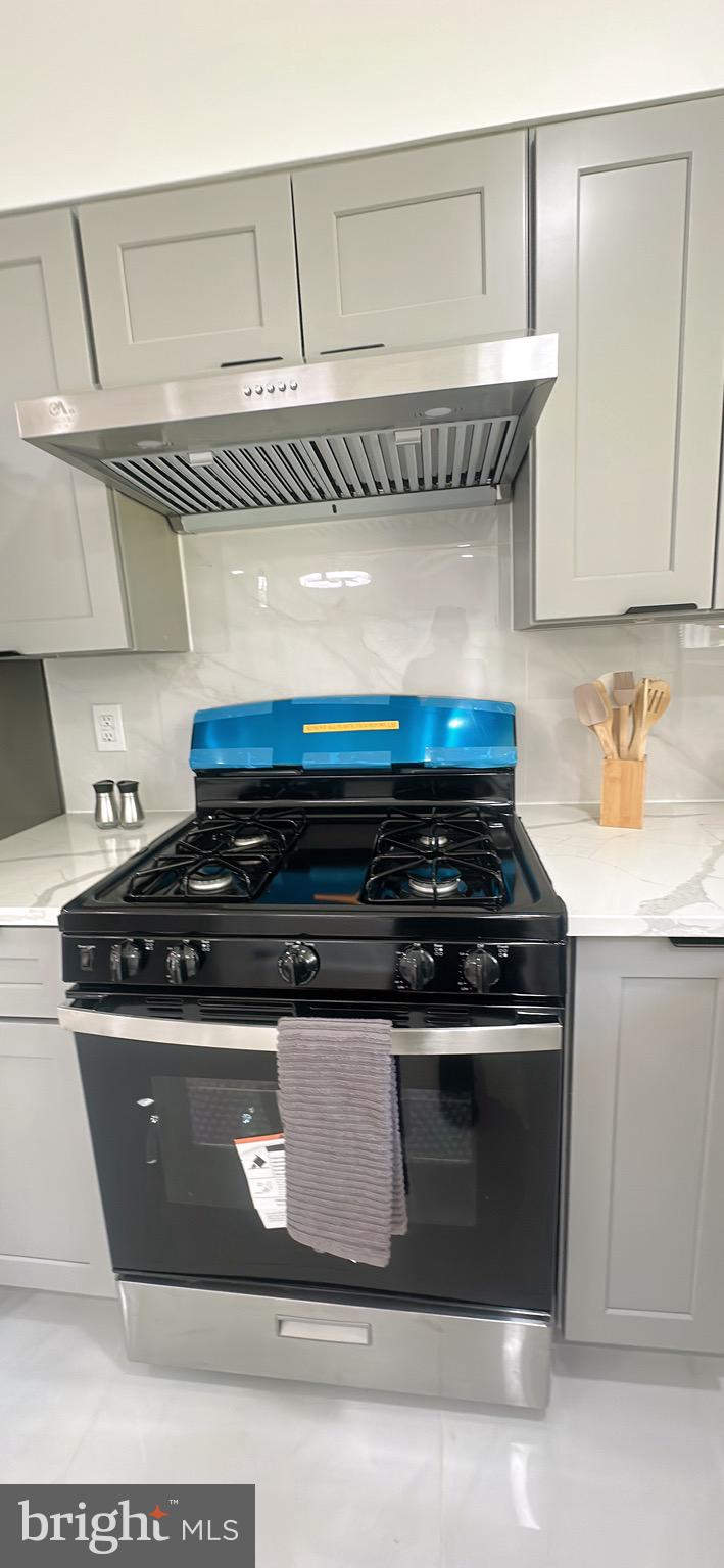 1242 June Road Huntingdon Valley, PA 19006 - Photo 13 of 47 a stove top oven sitting inside of a kitchen
