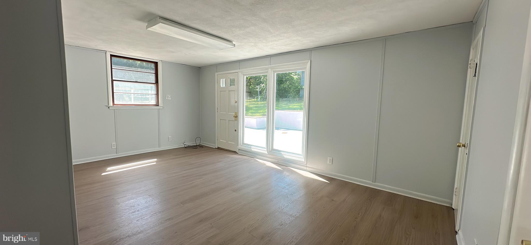 1242 June Road Huntingdon Valley, PA 19006 - Photo 18 of 47 an empty room with wooden floor and windows