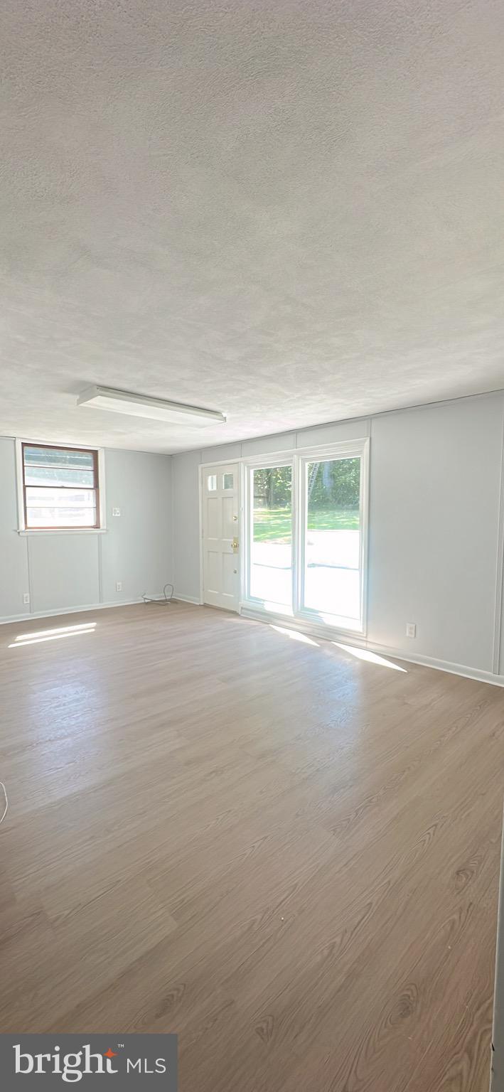 1242 June Road Huntingdon Valley, PA 19006 - Photo 19 of 47 an empty room with wooden floor and windows