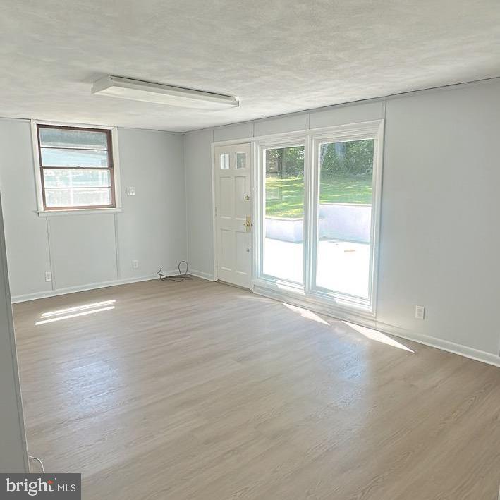 1242 June Road Huntingdon Valley, PA 19006 - Photo 21 of 47 an empty room with wooden floor and windows
