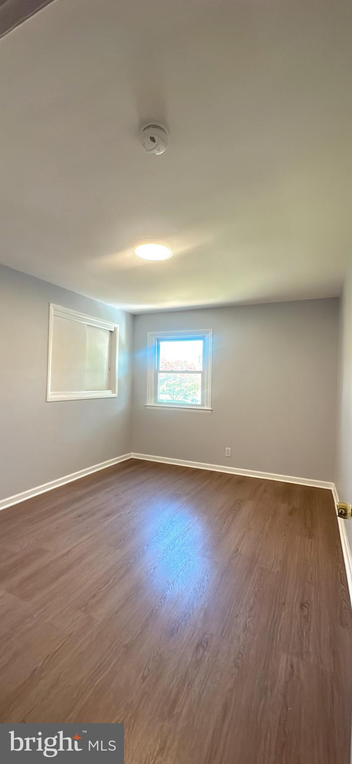 1242 June Road Huntingdon Valley, PA 19006 - Photo 25 of 47 an empty room with wooden floor and windows