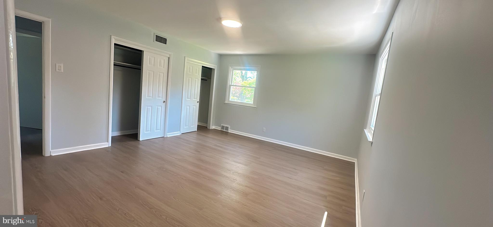 1242 June Road Huntingdon Valley, PA 19006 - Photo 28 of 47 an empty room with wooden floor and windows