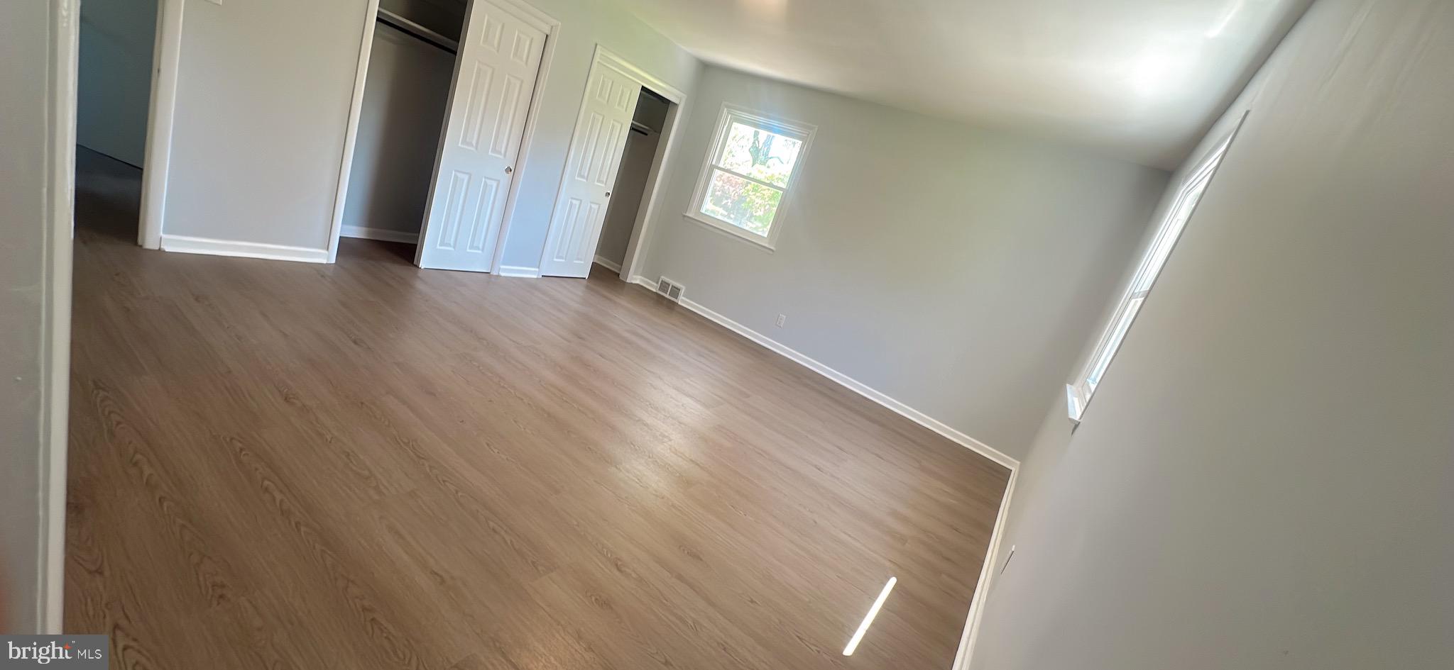 1242 June Road Huntingdon Valley, PA 19006 - Photo 29 of 47 a view of an empty room with wooden floor and a window